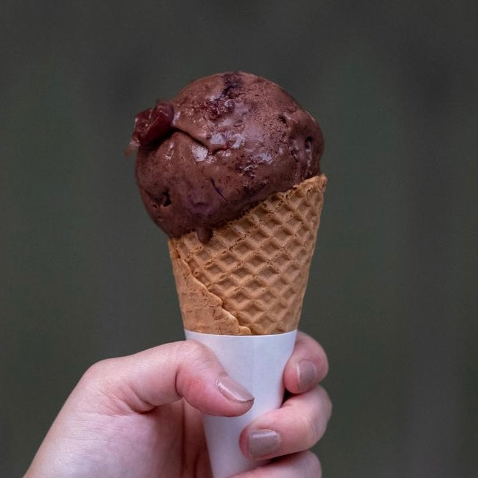 Experience pure indulgence with our Creamier Black Forest Ice Cream. Crafted with love, it features house-baked chocolate sponge cake, the finest Griottines black cherries soaked in kirsch, and a luscious dark chocolate couverture. Every spoonful is a journey through layers of rich, decadent flavors. 